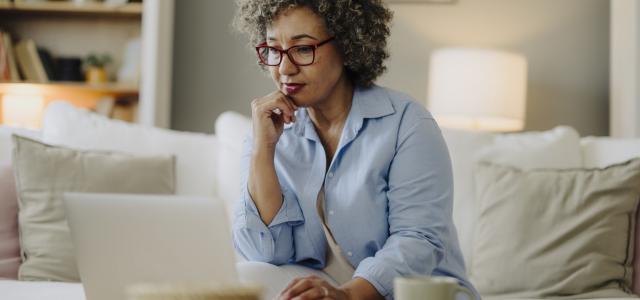 Lady thinking while using laptop